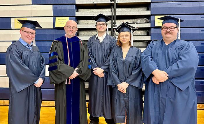 Spring 2023 graduates Joseph Gagermeier, Alicia Qatipi, Matthew Wolff, and Noah Plank standing with Teaching Professor Doug Page.